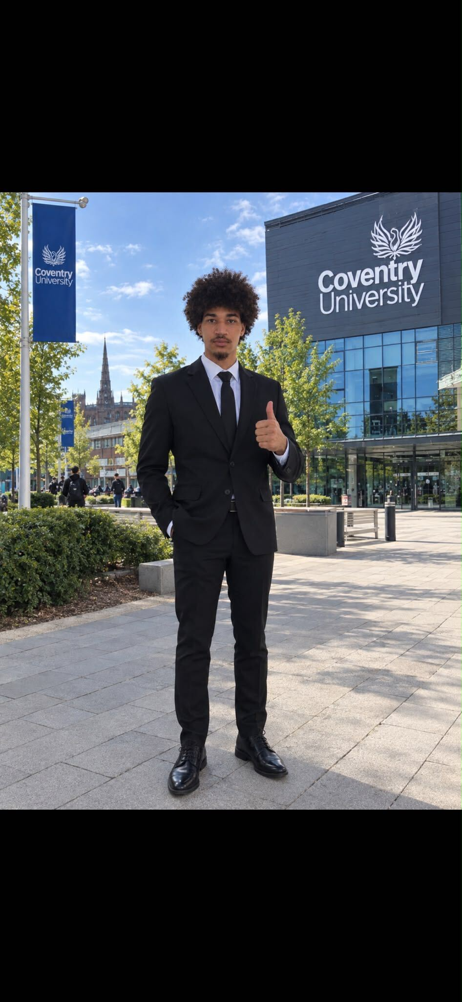 Mark Matthias Mclean standing outside Coventry University.